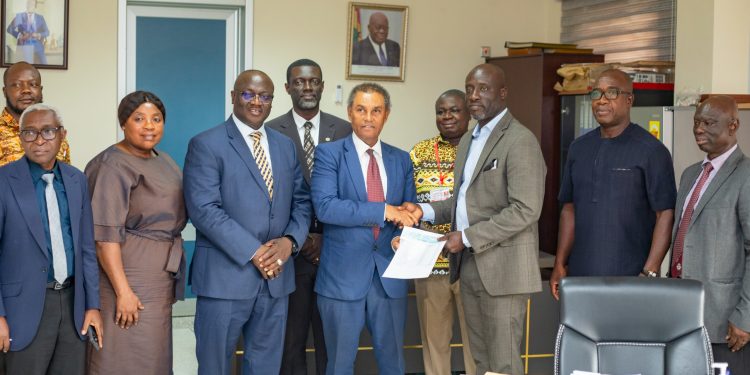The leader of the Chartered Accountants, Dr Robert Donaldy, presenting a cheque of GH¢160,000 to the chairman of the Heal Komfo Anokye Teaching Hospital, Sammy Adu Boakye.